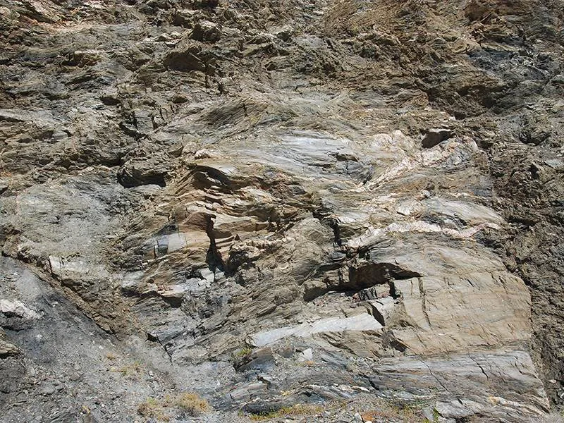 Micaseous schist, folded, with quartzite veins