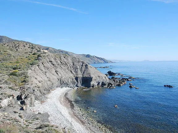 Rugged coast near Villaricos. Esperanza II in background